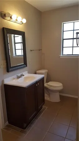 a bathroom with a sink toilet and mirror