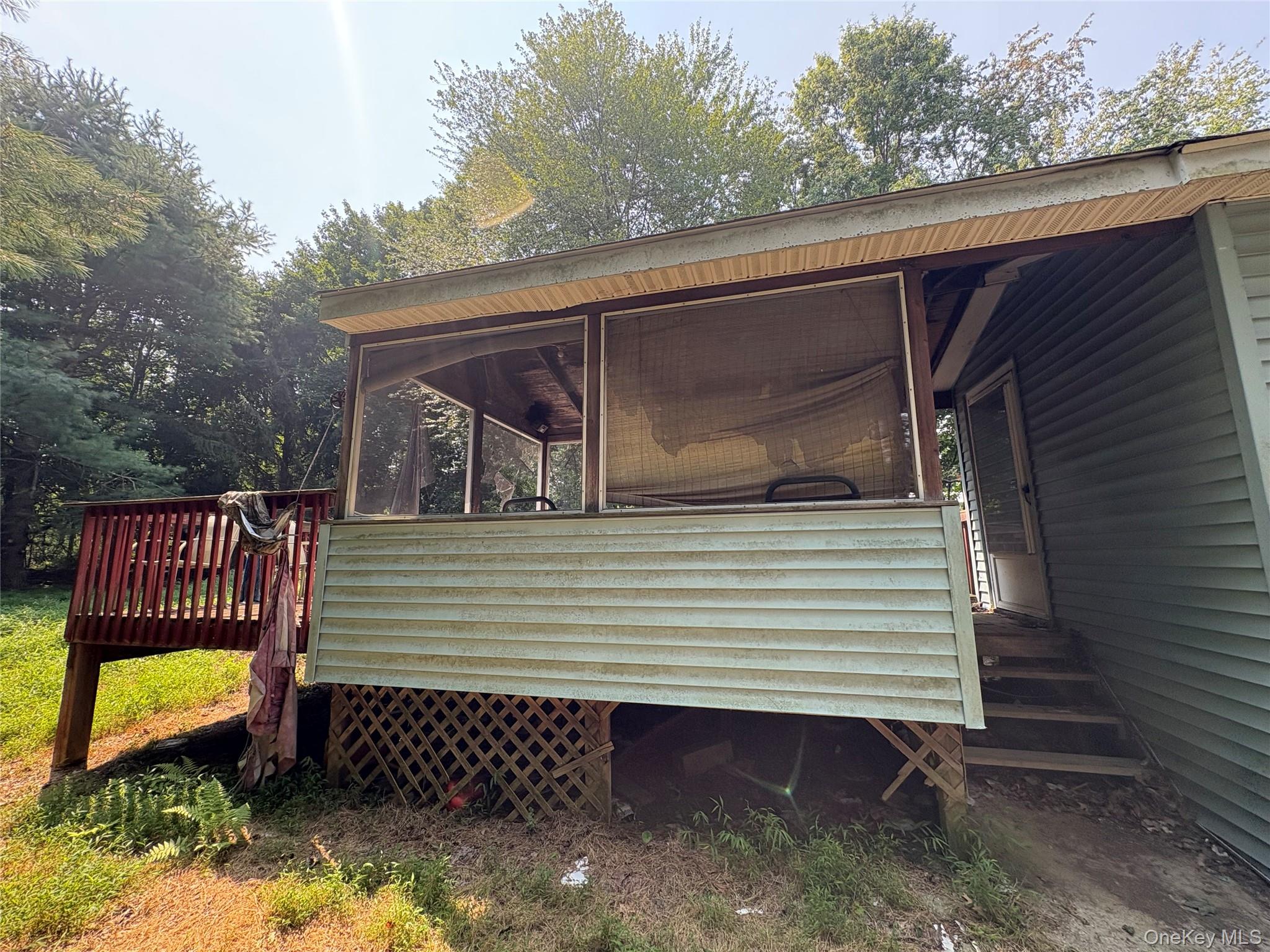 11 Chase Road Wallkill, NY 12589 - Photo 6 of 10 View of side of property with a sunroom and a deck
