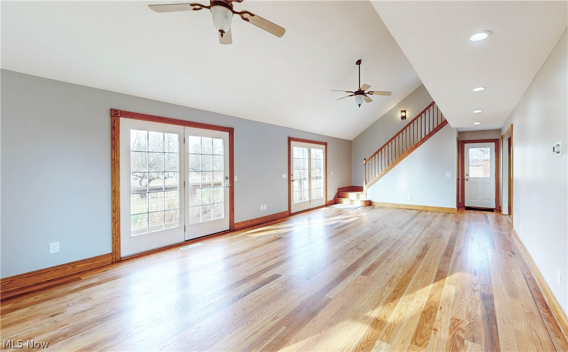 2081 Stroup Road Atwater, OH 44201 - Photo 28 of 48 Unfurnished living room with vaulted ceiling, light wood-type flooring, ceiling fan, and a healthy amount of sunlight