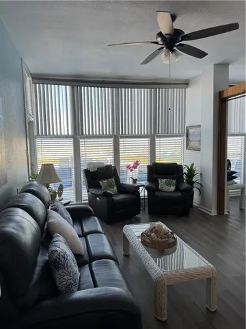 a living room with furniture wooden floor and a fireplace