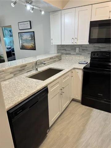 a bedroom with furniture and a flat screen tv