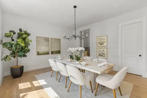 a kitchen with stainless steel appliances granite countertop a sink a stove and a wooden floors