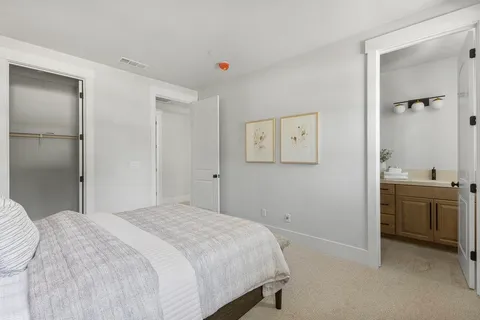 a living room with furniture a flat screen tv and a large window