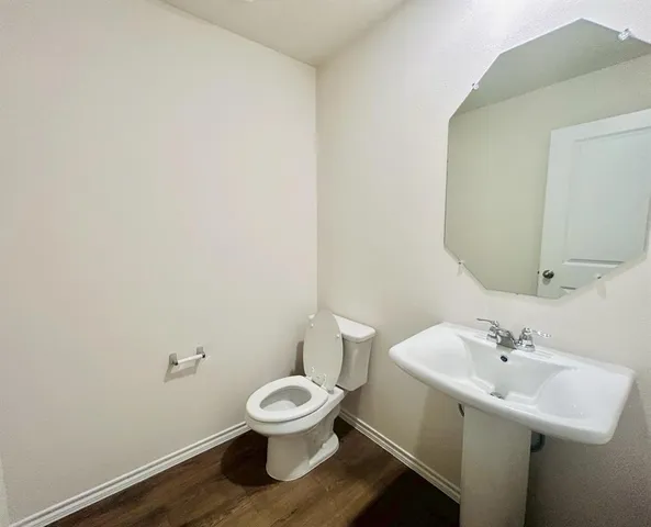 a white toilet sitting next to a bathroom sink
