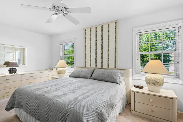 a bathroom with a granite countertop sink vanity mirror and toilet