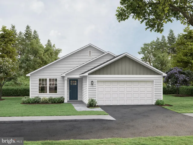 a front view of a house with a yard and potted plants
