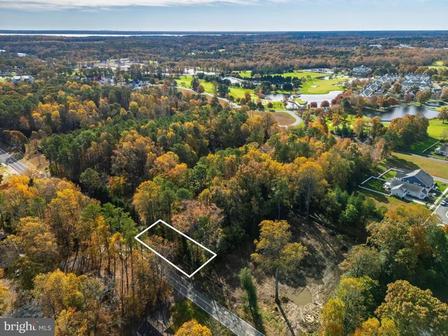 an aerial view of a residential houses with city view