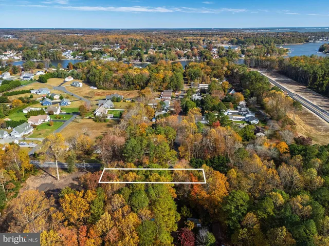 an aerial view of a residential houses with city view