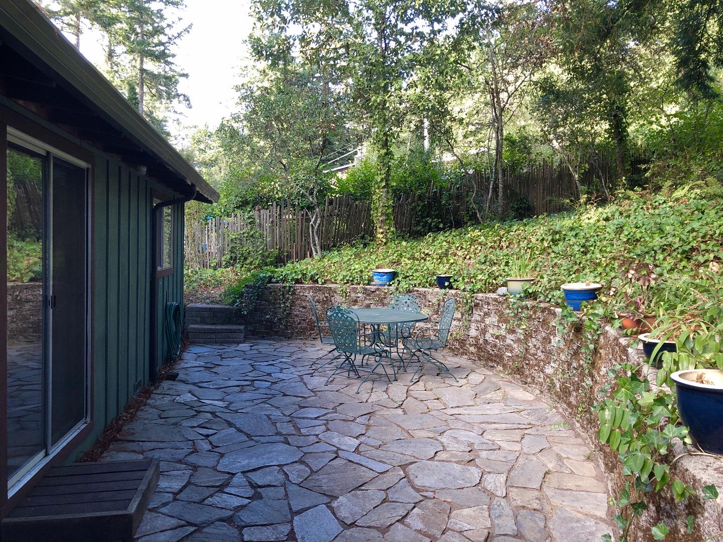 187 Chapman Road Woodside, CA 94062 - Photo 17 of 29 a view of a chair and table in backyard of the house