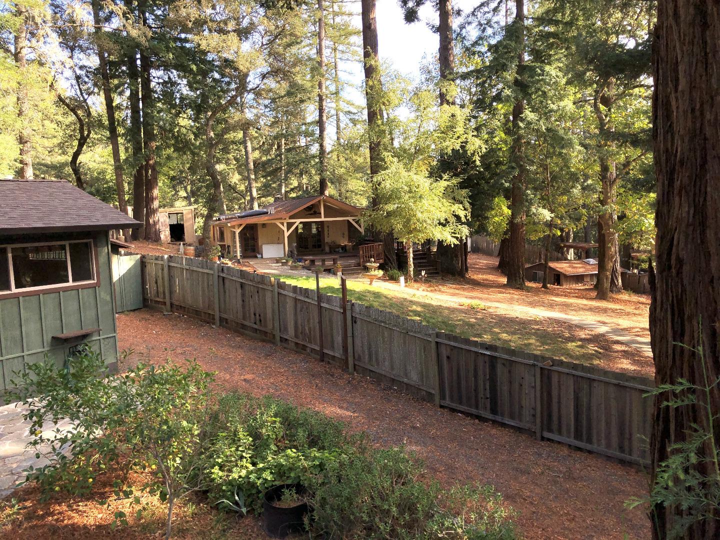 187 Chapman Road Woodside, CA 94062 - Photo 26 of 29 a view of a house with large trees and wooden fence