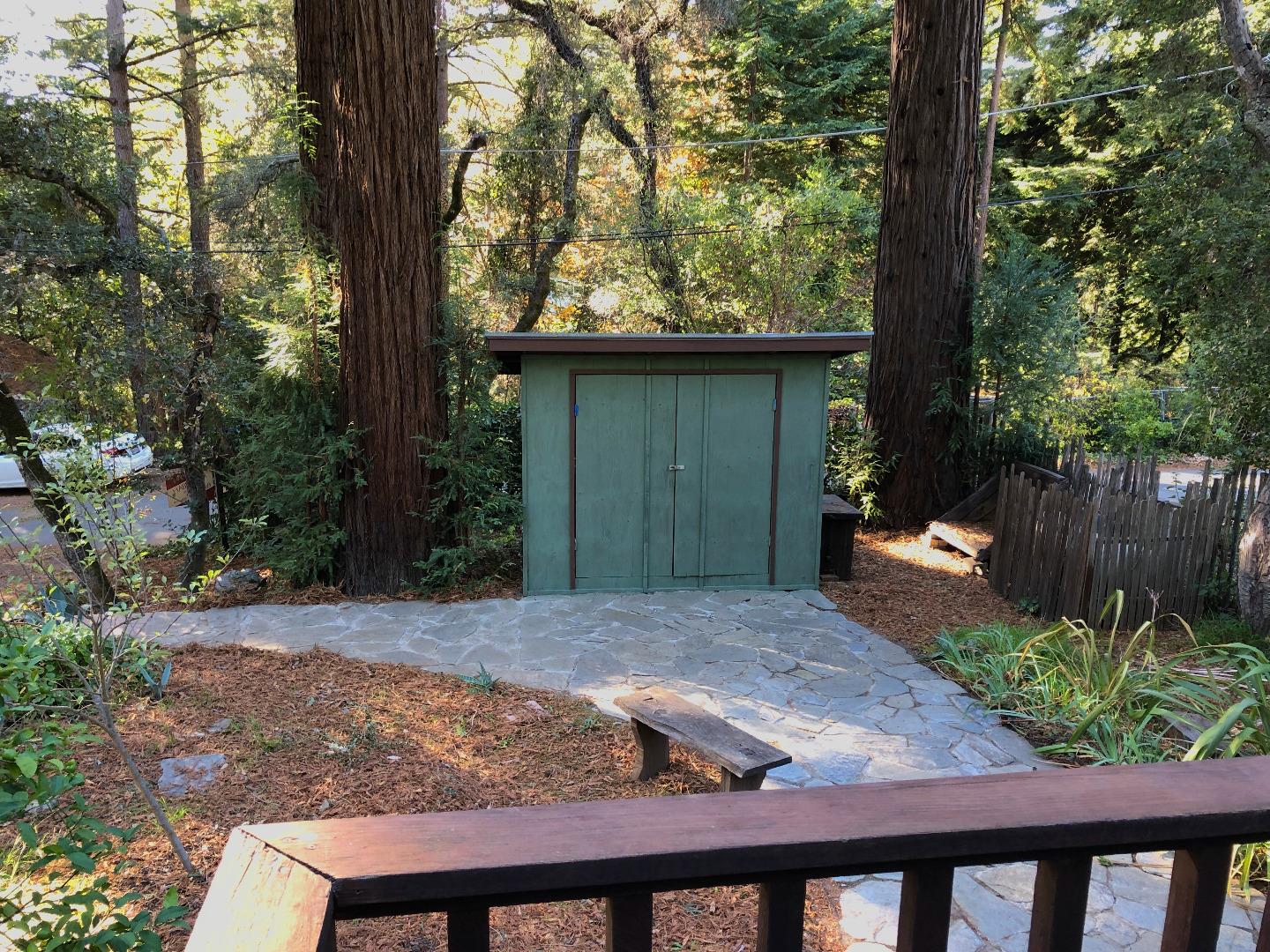 187 Chapman Road Woodside, CA 94062 - Photo 27 of 29 a view of a backyard with large trees and wooden fence