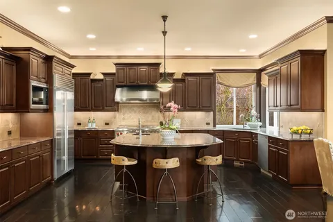 a kitchen with a sink stove top oven and cabinets