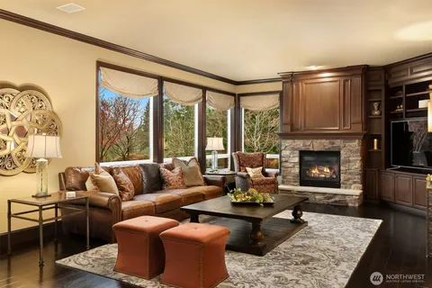 a living room with furniture and a floor to ceiling window