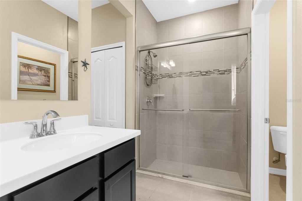 6283 Grapewood Road Spring Hill, FL 34609 - Photo 25 of 41 a bathroom with a shower sink and mirror