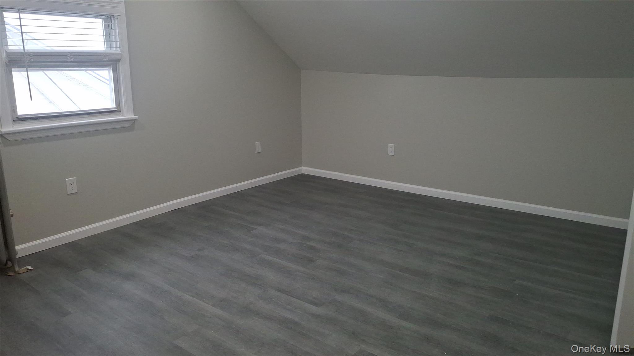 194-14 115th Road, Unit 2 Queens, NY 11412 - Photo 5 of 11 Additional living space with lofted ceiling and dark wood-style flooring