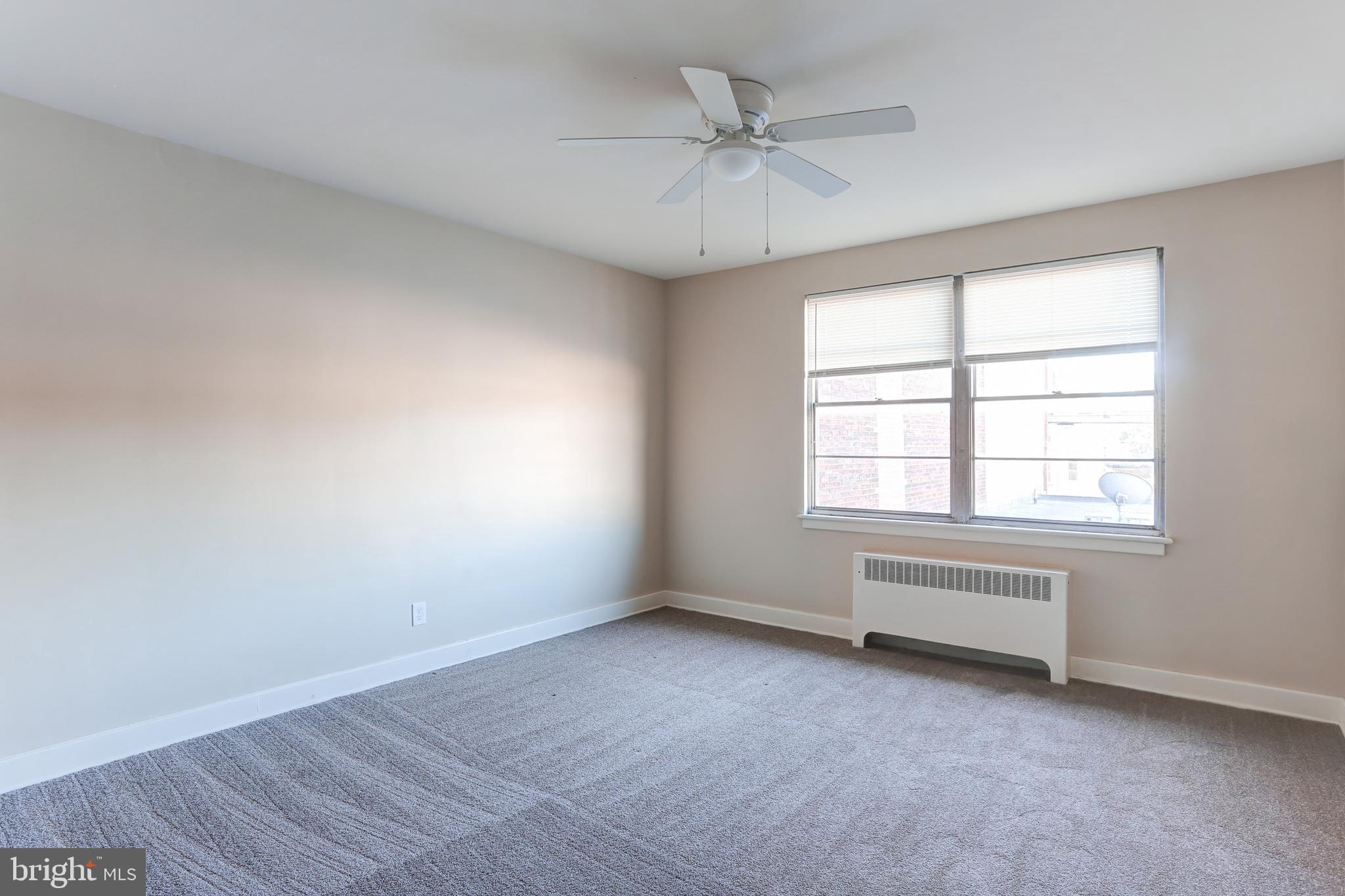 310 Bridge Street, Unit A New Cumberland, PA 17070 - Photo 5 of 7 wooden floor in an empty room with a window