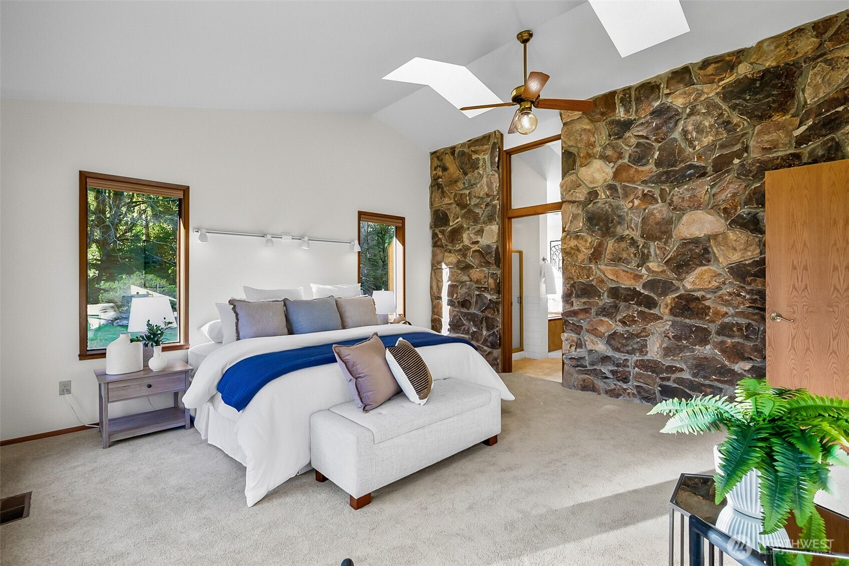 14630 High Bridge Road Monroe, WA 98272 - Photo 12 of 40 a spacious bedroom with a bed and a potted plant