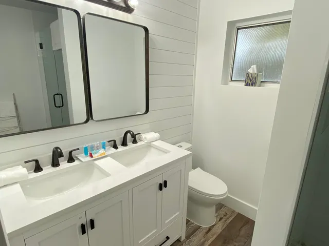 a bathroom with a toilet sink and mirror