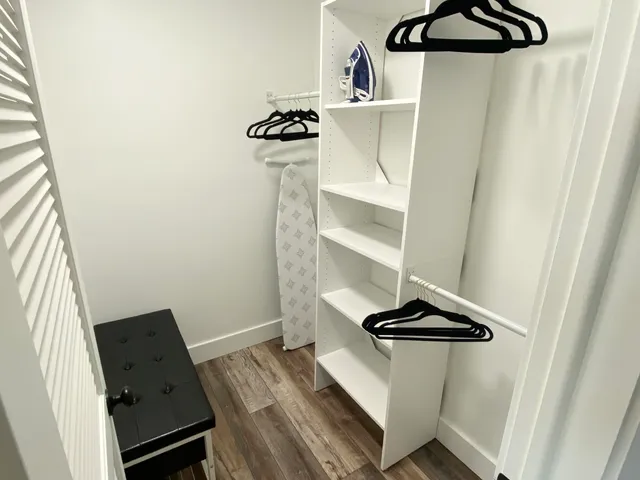 a view of a room with rack on the wall and a window