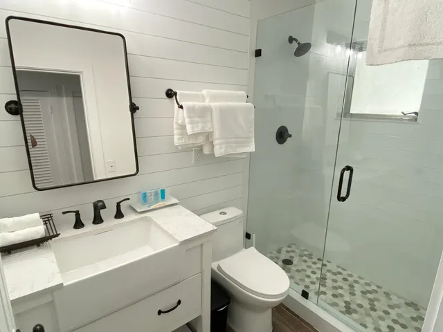 a bathroom with a sink toilet and shower