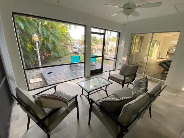 a living room with furniture and a floor to ceiling window
