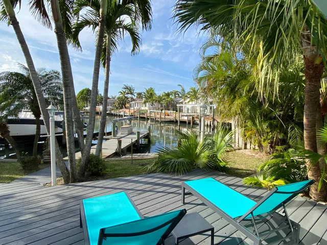 a view of a backyard with plants and swimming pool