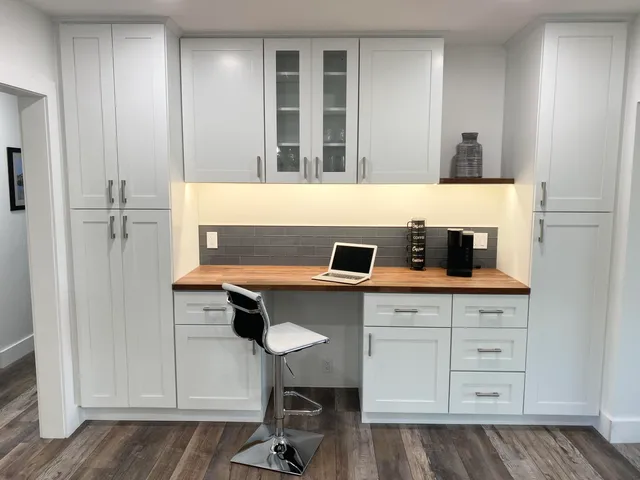 a room with a chair and cabinets