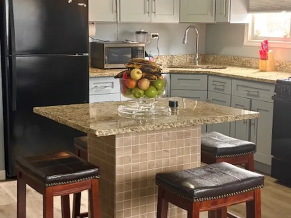 a kitchen island with a stove and a table