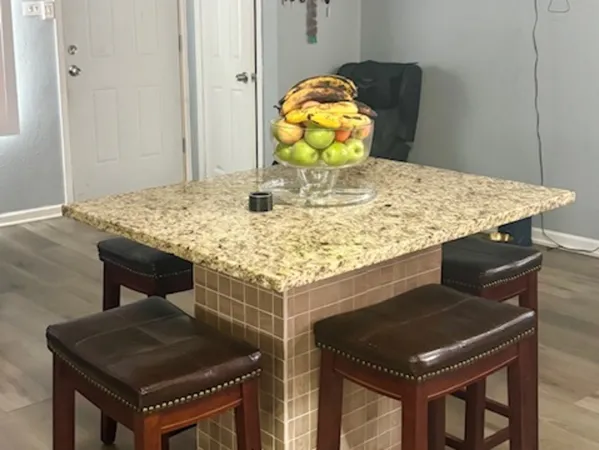 a kitchen with kitchen island a refrigerator stove a sink and dishwasher