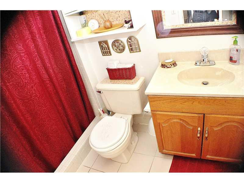 22170 Southwest 64th Way Boca Raton, FL 33428 - Photo 12 of 17 a bathroom with a toilet and a sink