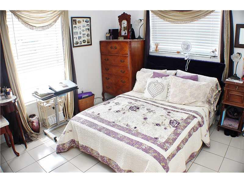 22170 Southwest 64th Way Boca Raton, FL 33428 - Photo 13 of 17 a bed sitting in a bedroom next to a window