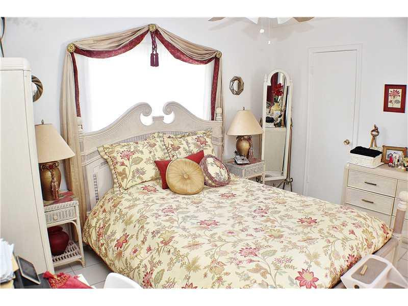 22170 Southwest 64th Way Boca Raton, FL 33428 - Photo 8 of 17 a bedroom with a bed and a dresser