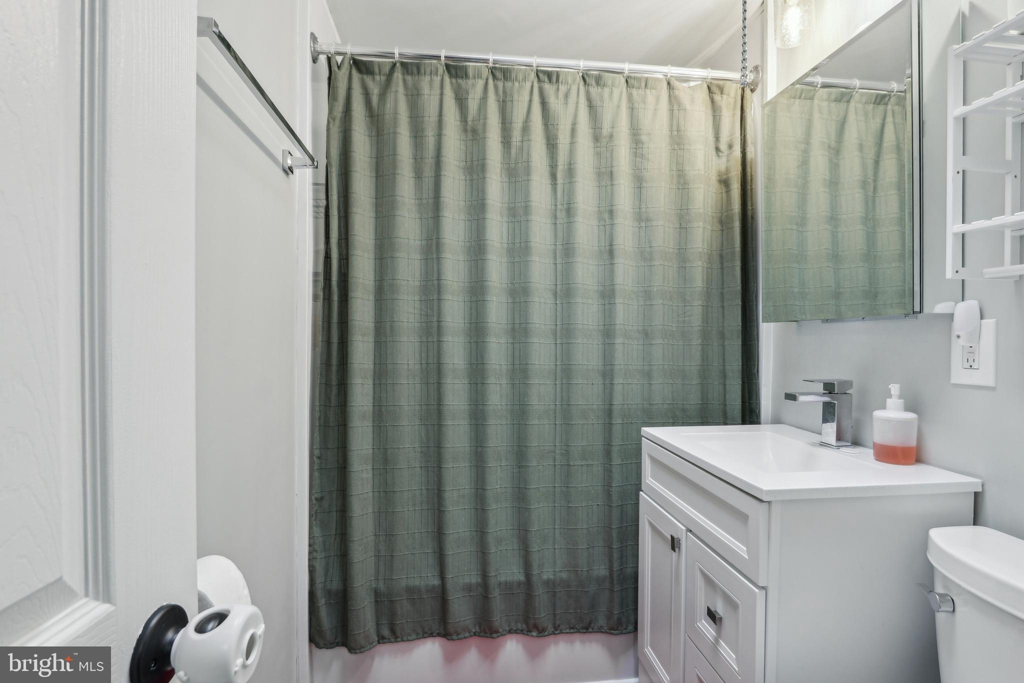 3207 Fairdale Road Philadelphia, PA 19154 - Photo 36 of 49 a bathroom with a sink a toilet and shower curtain