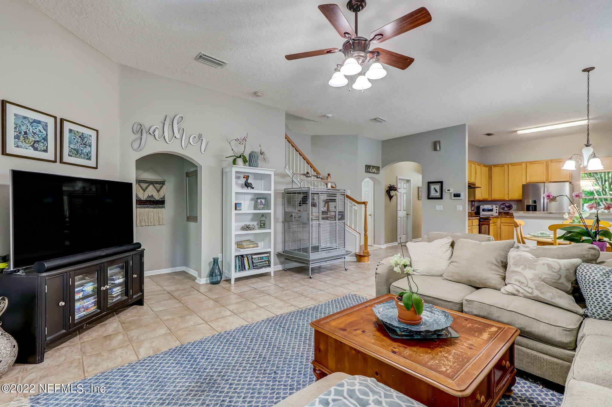96692 Commodore Point Drive Yulee, FL 32097 - Photo 13 of 38 a living room with furniture a flat screen tv and kitchen view