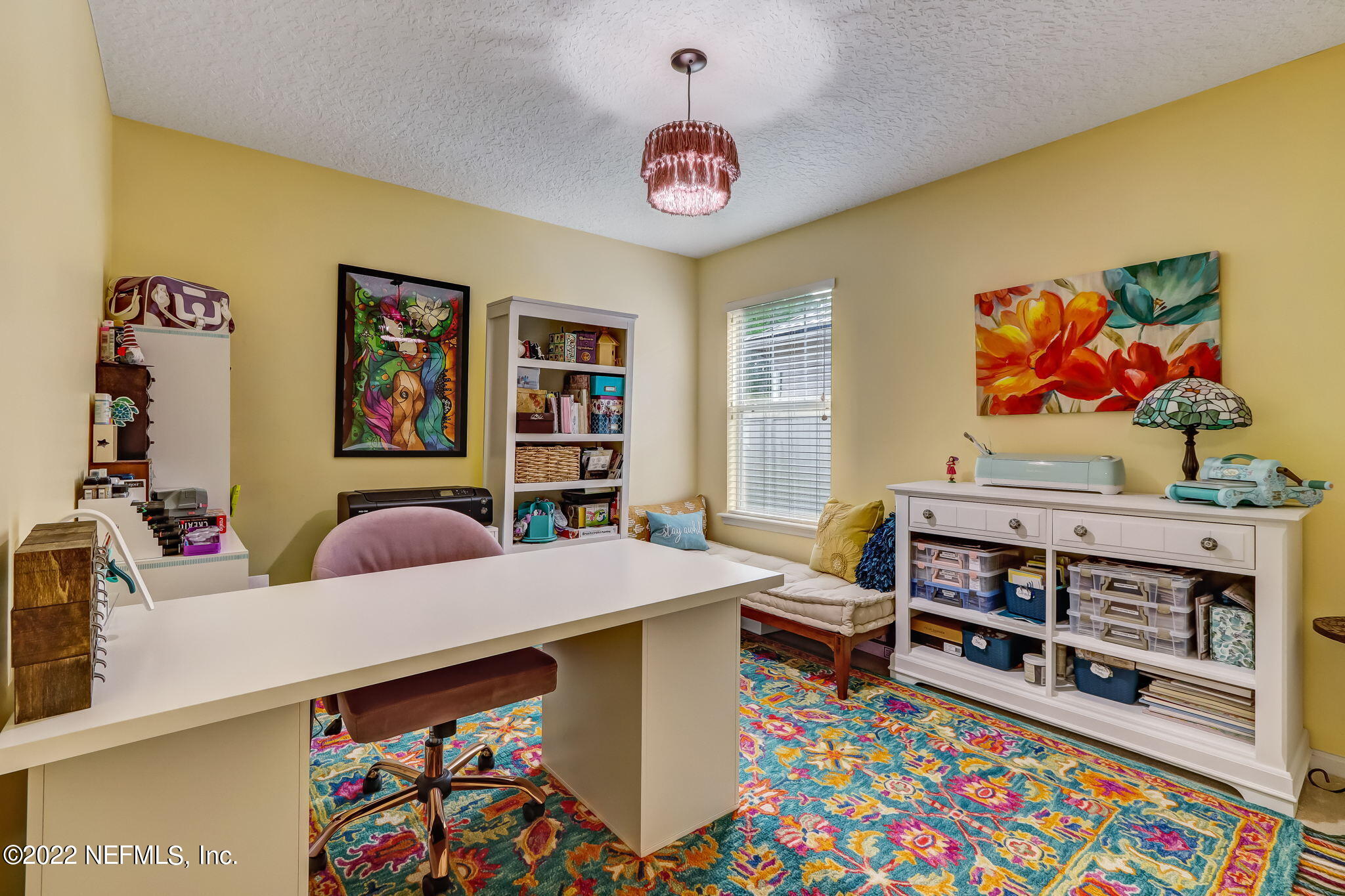 96692 Commodore Point Drive Yulee, FL 32097 - Photo 22 of 38 a living room with furniture and a baby crib