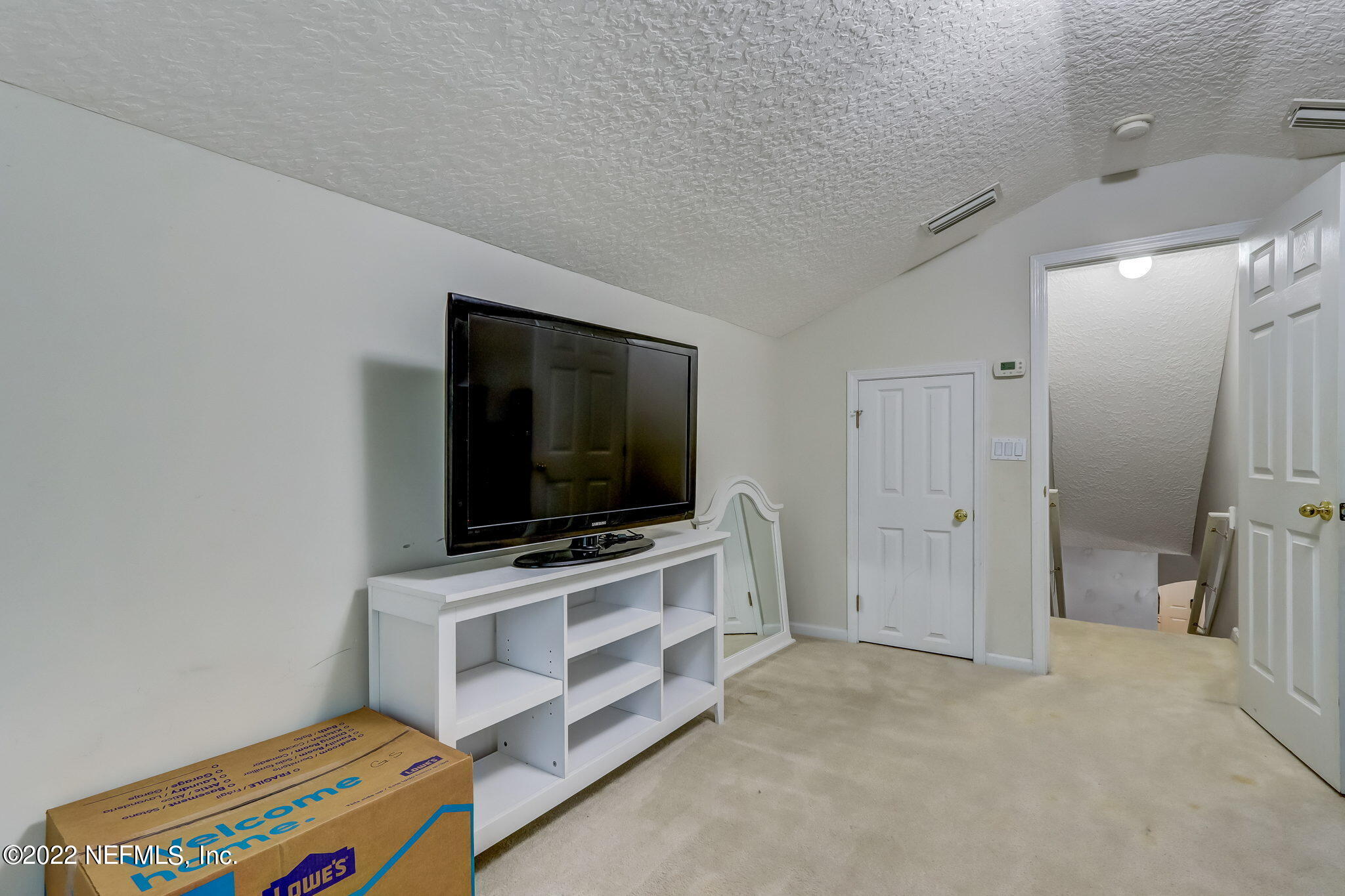 96692 Commodore Point Drive Yulee, FL 32097 - Photo 27 of 38 a living room with furniture and a flat screen tv