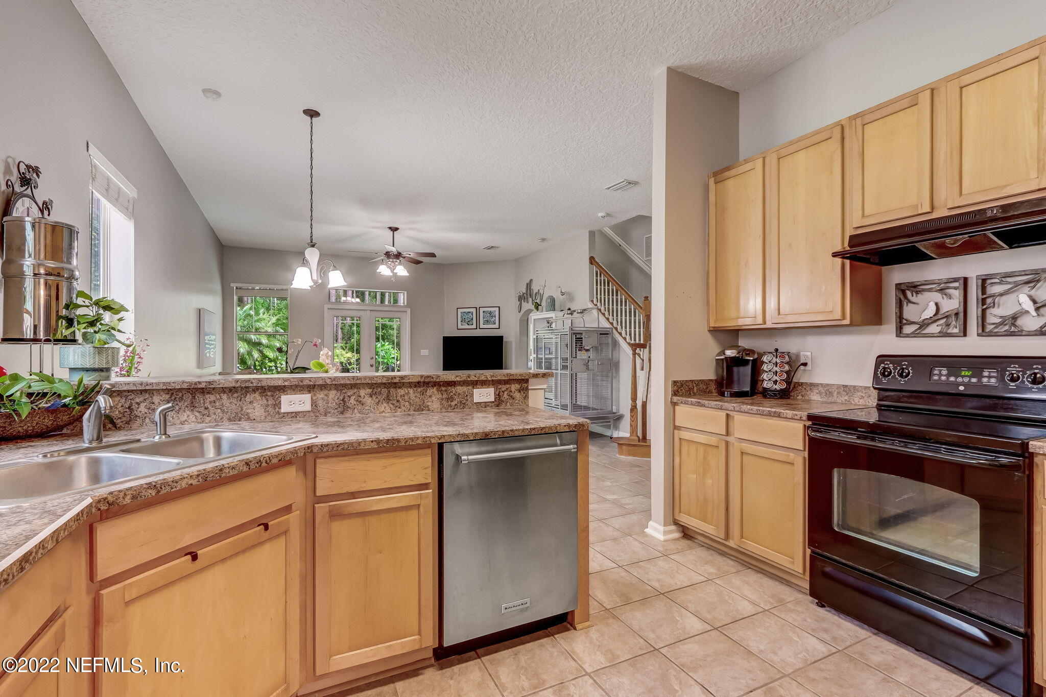 96692 Commodore Point Drive Yulee, FL 32097 - Photo 7 of 38 a kitchen with stainless steel appliances granite countertop a sink a stove and cabinets