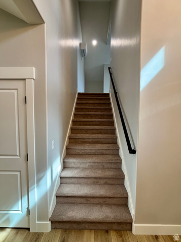 1184 West 3250 North Ogden, UT 84414 - Photo 23 of 69 Carpeted staircase featuring a matte black handrail, recessed lighting, and a wall-mounted mini-split unit