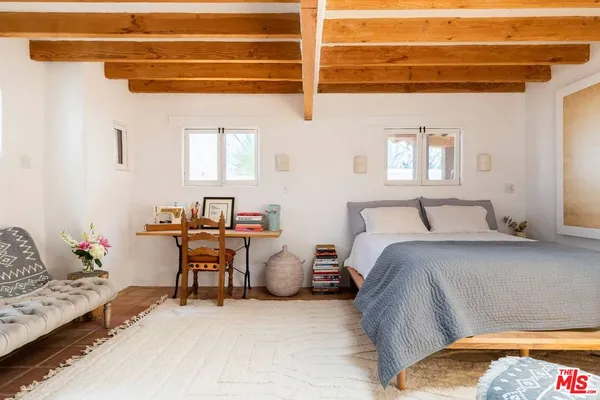 a bedroom with furniture and a window