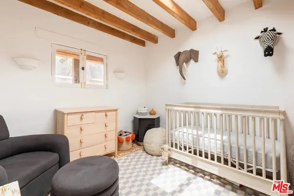 a bedroom with furniture and a window