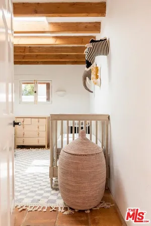 a view of a living room with a baby crib