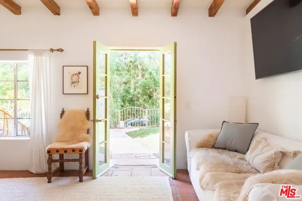 a bedroom with a bed and glass window