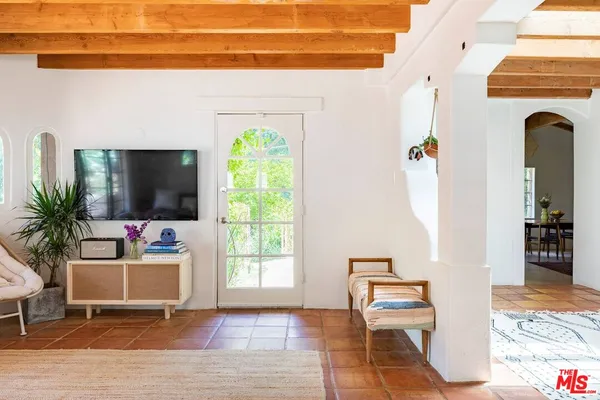 a living room with furniture and a flat screen tv