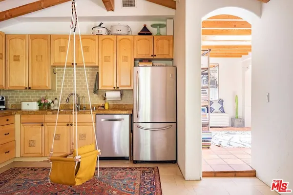 a kitchen with refrigerator and window