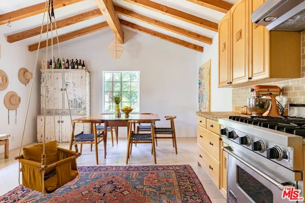 a dining room with furniture and window
