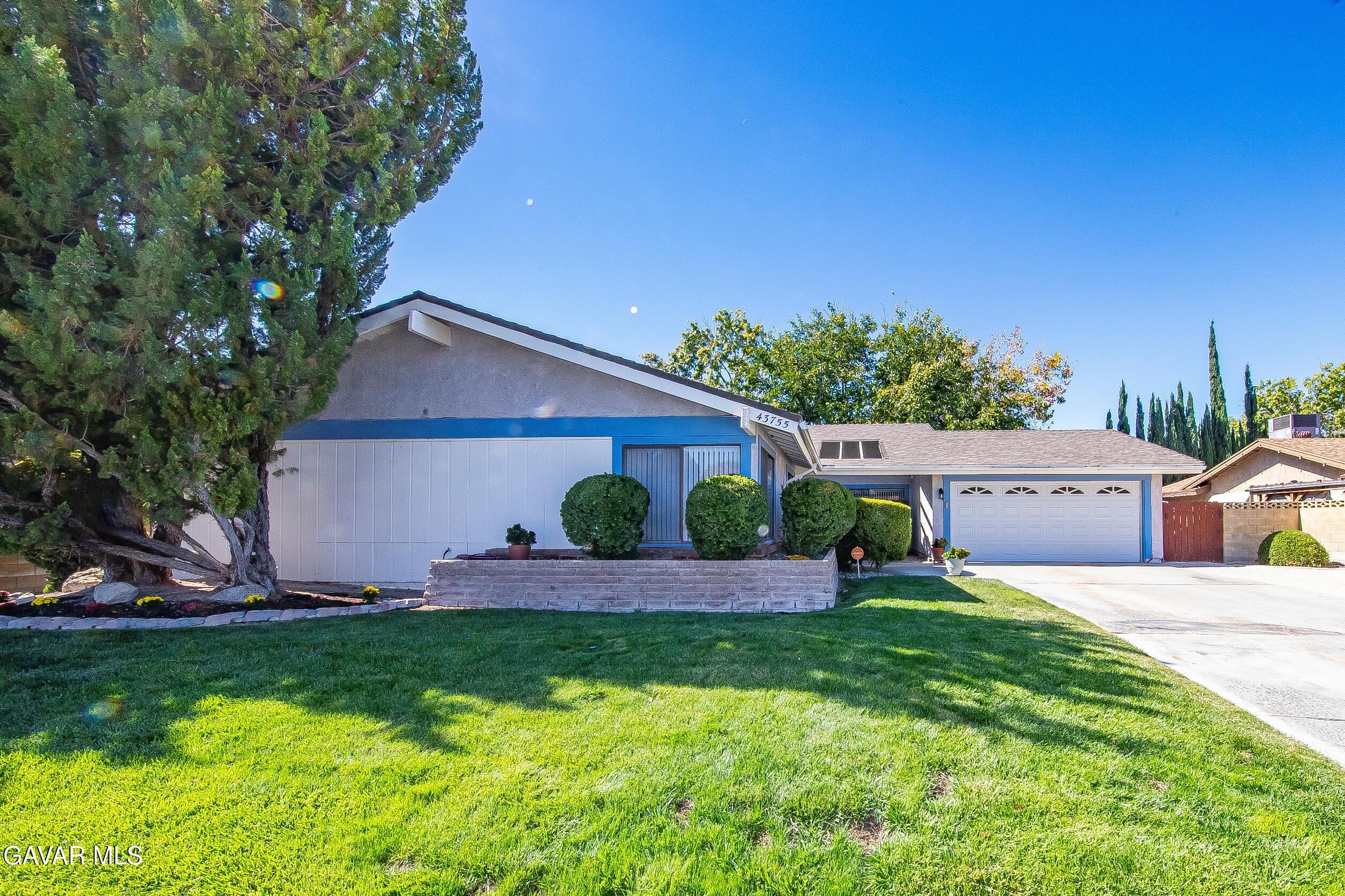 43755 Sentry Lane Lancaster, CA 93536 - Photo 1 of 36 a front view of a house with a yard and garage