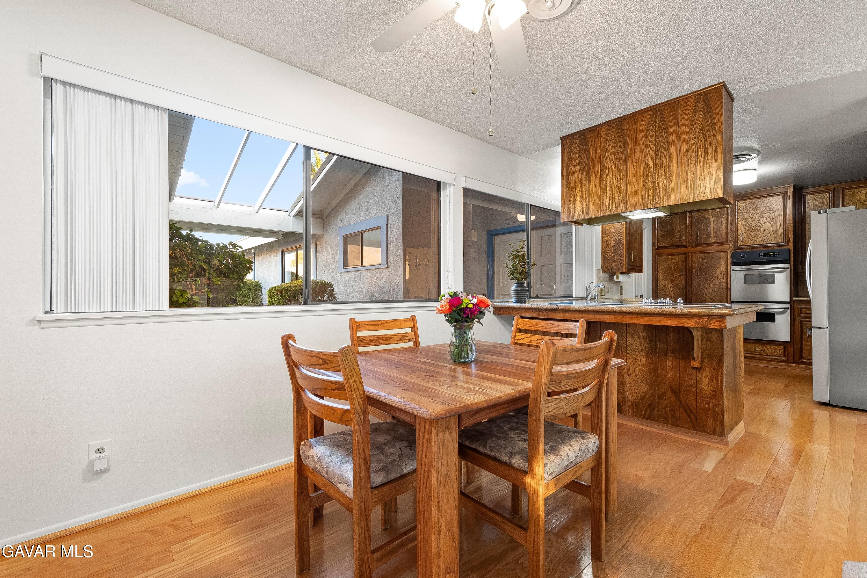 43755 Sentry Lane Lancaster, CA 93536 - Photo 15 of 36 a dining room with furniture a floor to ceiling window and wooden floor
