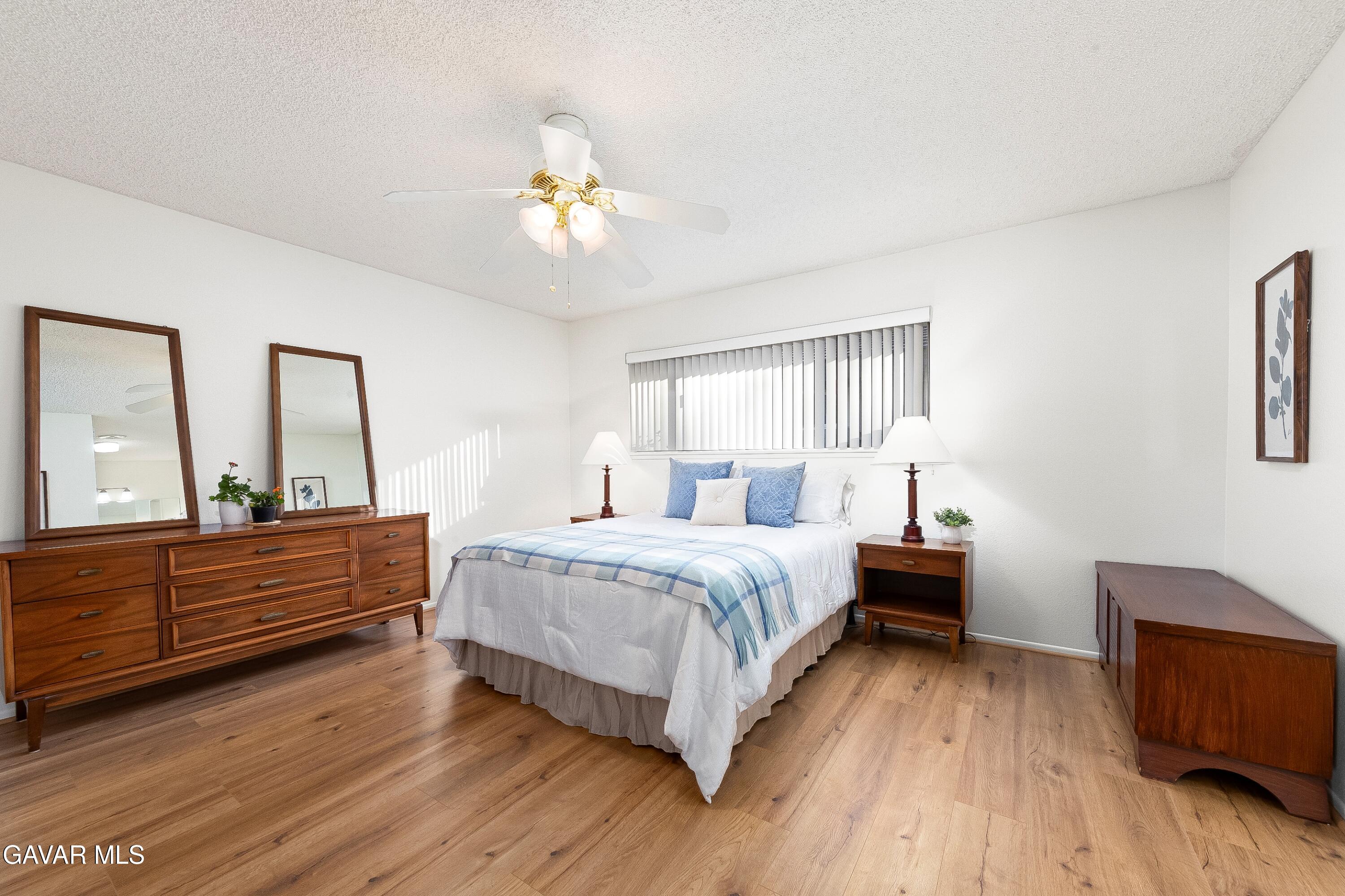 43755 Sentry Lane Lancaster, CA 93536 - Photo 17 of 36 a spacious bedroom with a bed and a dresser