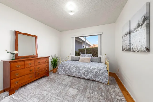 a bedroom with a large bed and a dresser