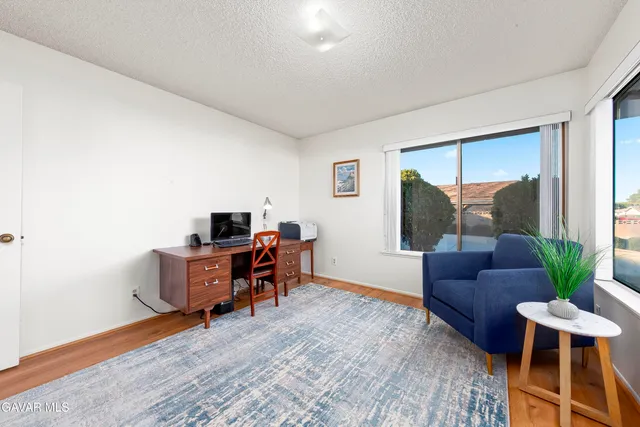 a workspace with furniture and a potted plant